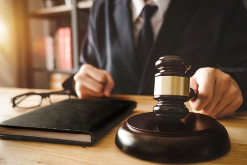 judge seated at a desk with gavel in hand