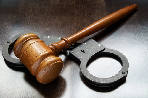 Gavel and handcuffs - post-conviction relief in California can negate some of the consequences of a criminal conviction