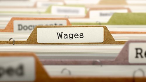file folder marked "wages" - employers in California can be liable for back pay, interest and penalties on unpaid wages