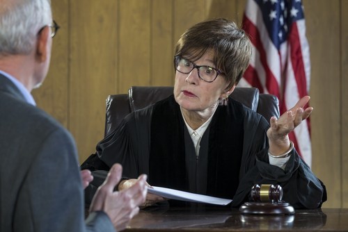 female judge listening to male lawyer