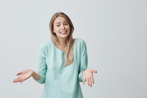 woman extending her hands as if to suggest that she was unaware of something