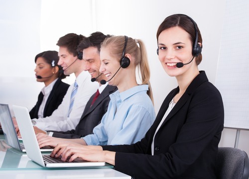 five law firm receptionists with laptops and headsets on
