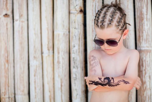 young child with fake tattoos