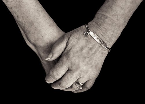 Elderly lady's hands wearing diabetes bracelet - diabetics with ketoacidosis can register falsely high readings on the DUI breathalyzer 