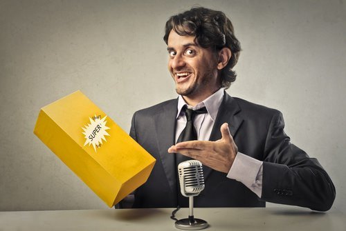 suited man at microphone pointing to a yellow boxed product that he is promoting as an example of what could be false advertising in violation of Business and Professions Code 17500