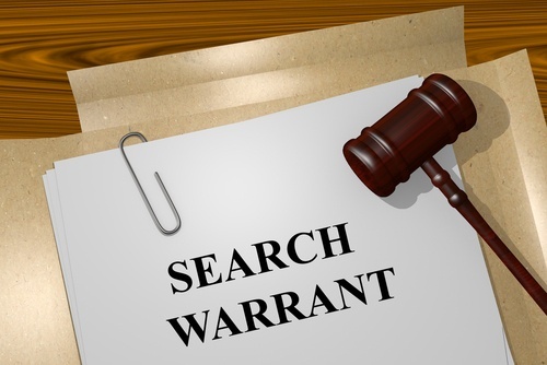 A search warrant under a judge's gavel