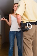 Policeman cornering a woman