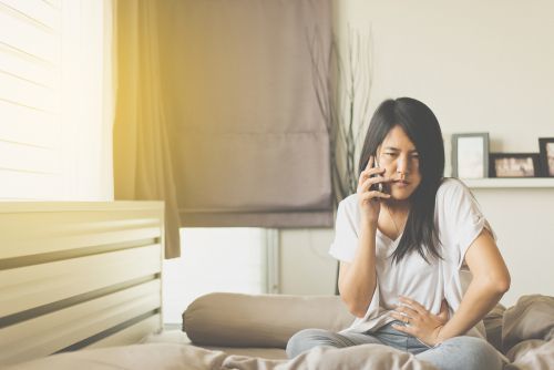girl in pain in her bed