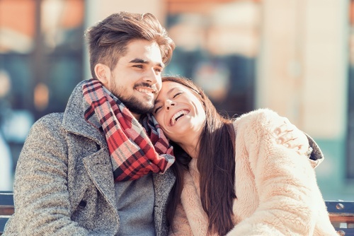 happy male and female couple snuggling