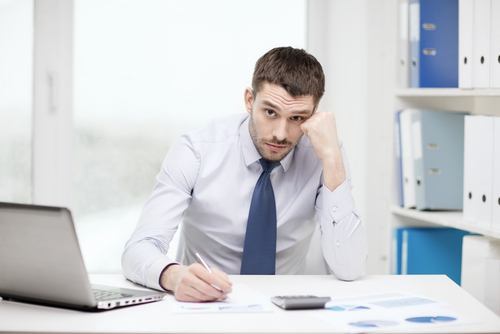 Man in suit seated and composing a letter - a demand letter in a California injury case is a common ways to resolve a claim informally