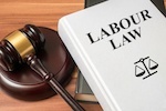 book with "labor law" title and gavel