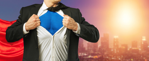 man in suit with superman suit underneath