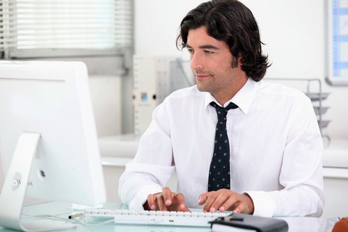 man working on computer as an example of light duty or modified work