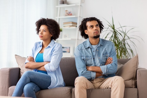 African American couple on sofa not looking at each other
