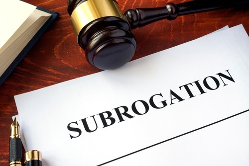 gavel with "subrogation" typed on paper