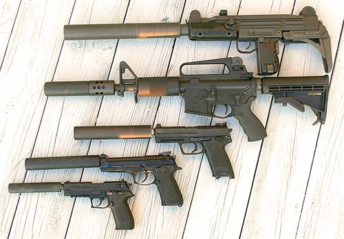 various firearms with silencers attached