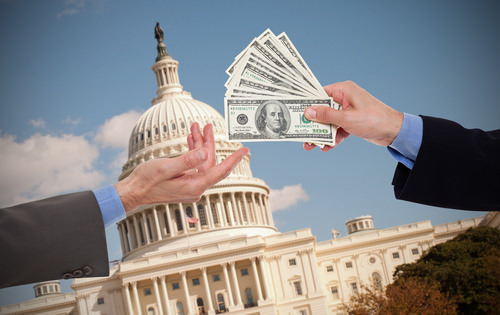 money exchanging hands in front of government building as an example of Penal Code 518 PC extortion in California