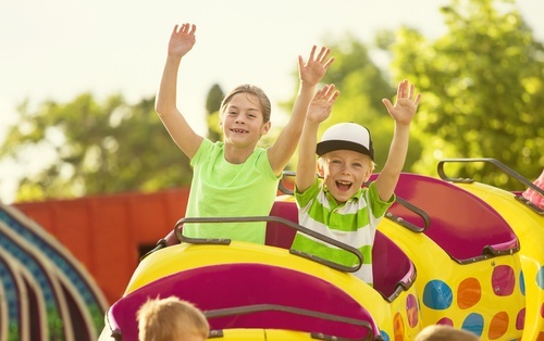 two children on kiddie coaster