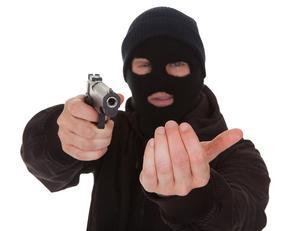 Masked man with gun holding someone up in violation of NRS 200.380.