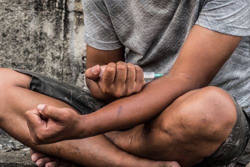 man injecting heroin via needle