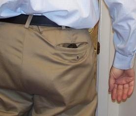 Concealed gun in man's back pocket