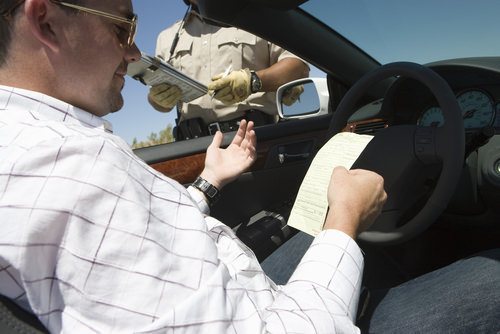 man receiving traffic ticket from officer