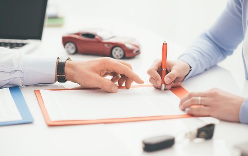 People's hands working on a legal document