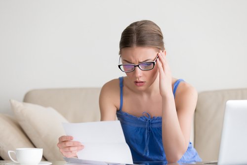 young lady reading threatening letter