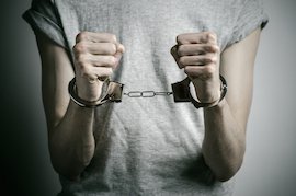 young man in handcuffs