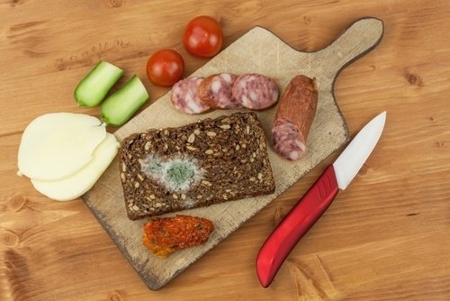 cutting board with meats and cheeses