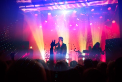 concert with multi-colored lights and large audience