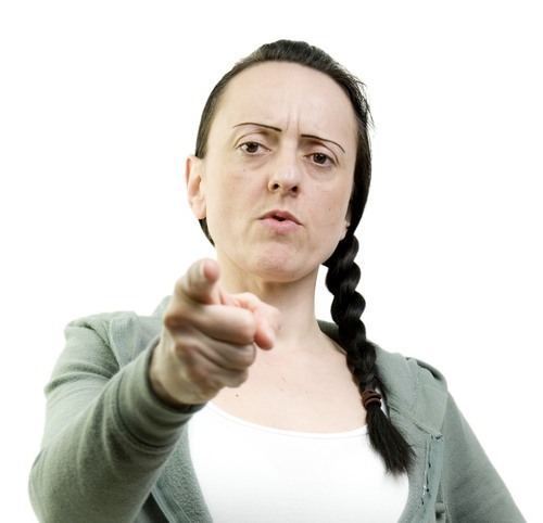 angry young woman pointing her finger toward the viewer - suing someone for sexual assault is an option for rape victims