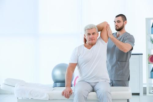 man receiving physical therapy as an example of a workers' compensation benefit in California