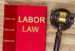 book with "labor law" title and gavel