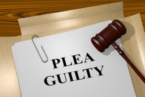 Gavel and paper that says plea guilty