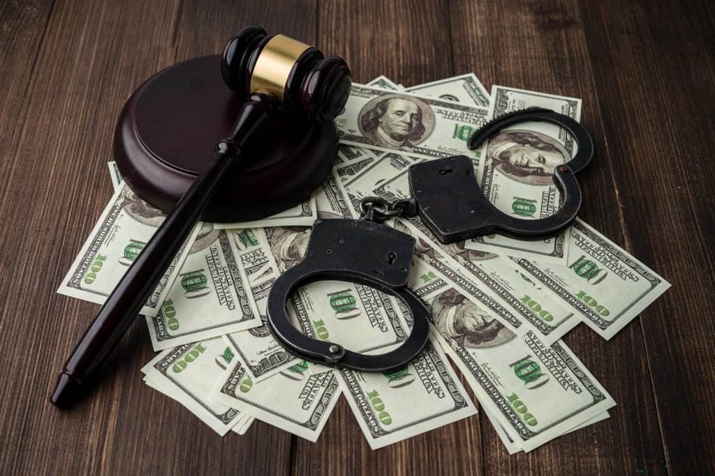 Cash, handcuffs, and a gavel