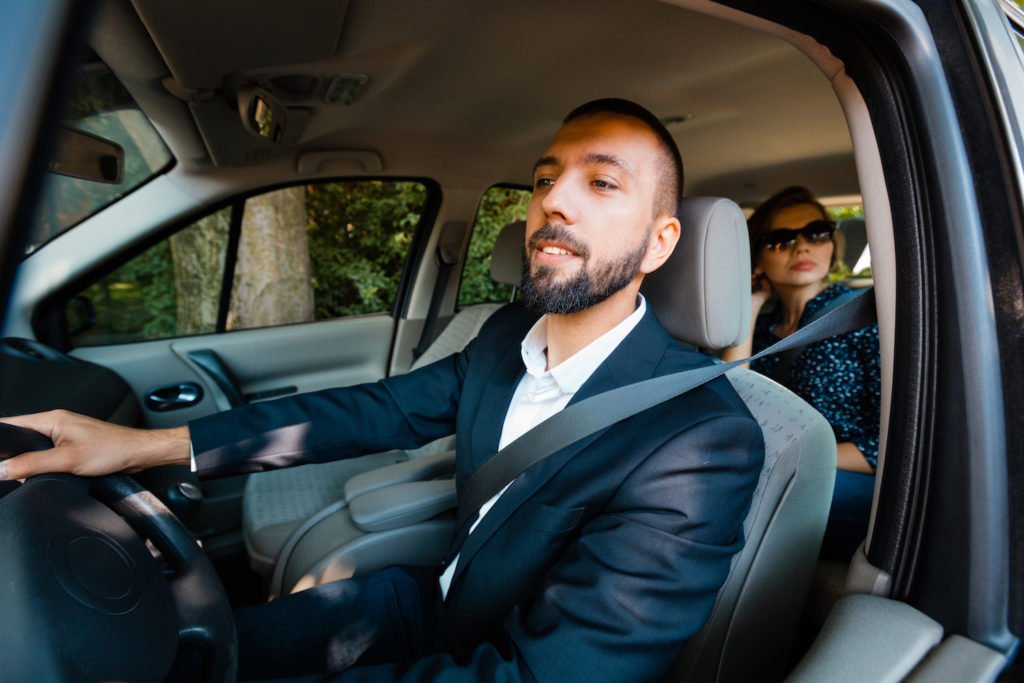 Ride-sharing driver with passenger in backseat