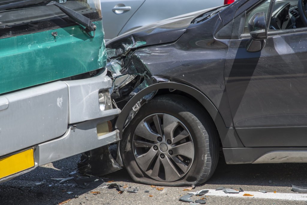 Aftermath of crash between car and bus