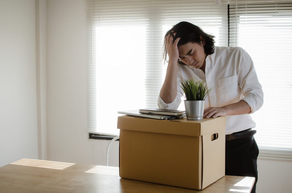 Fired worker packing up desk after being retaliated against for filing a workers' comp claim