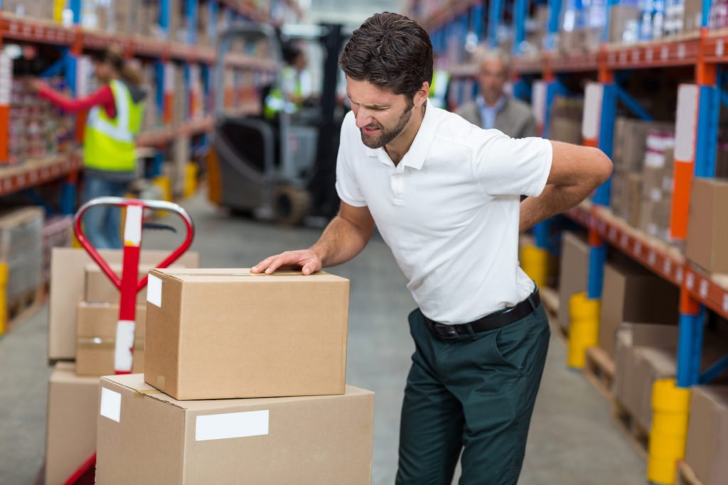 Workman lifting boxes with back injury