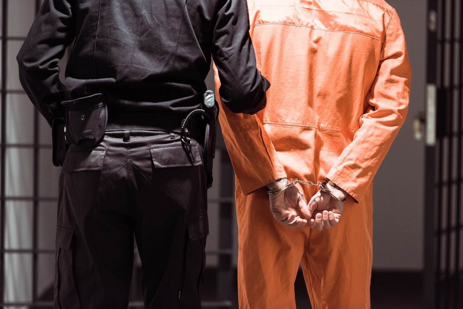 A prisoner being led away by a guard