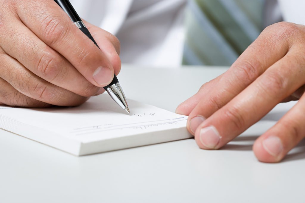 Close-up of hand forging prescription in violation of Business & Professions Code 4324 BPC