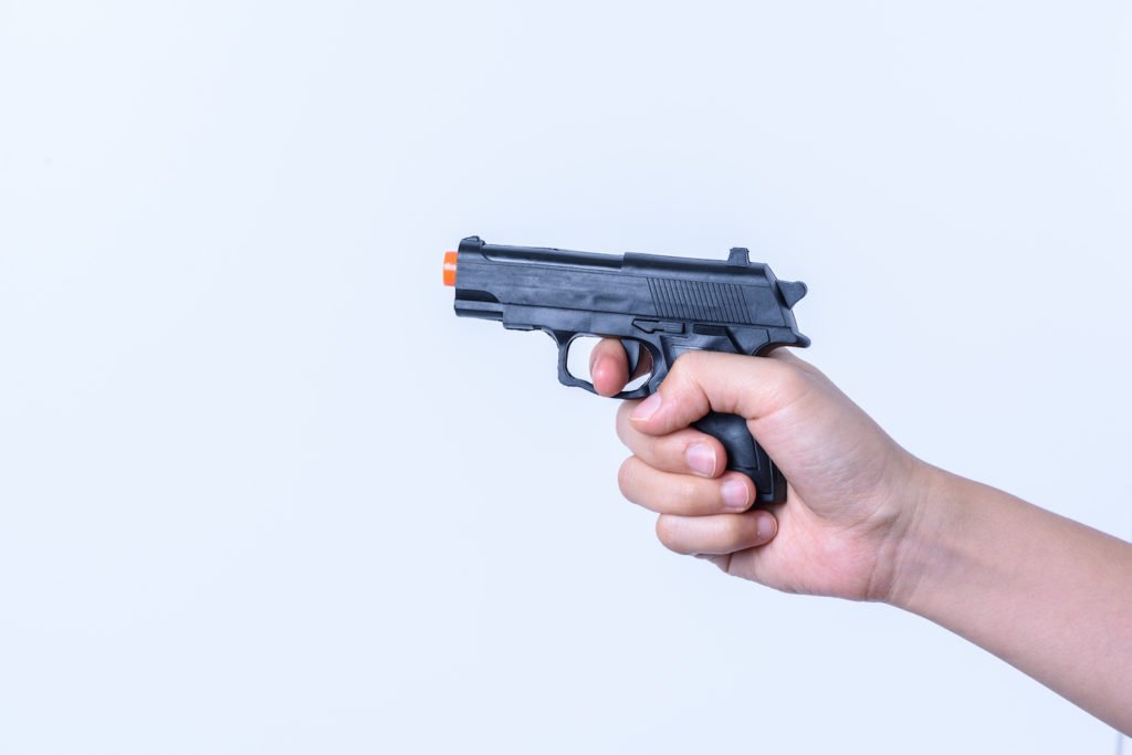 Hand pointing a toy gun as an example of brandishing an imitation firearm in violation of Penal Code 417.4 PC