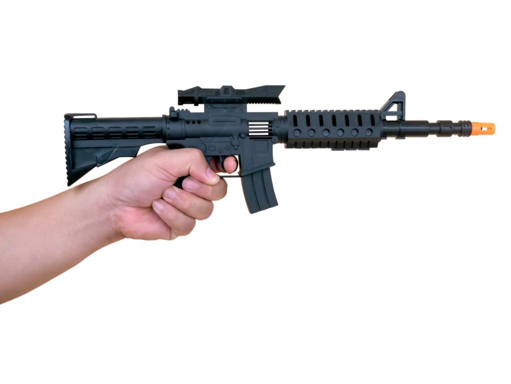 Hand holding a toy rifle