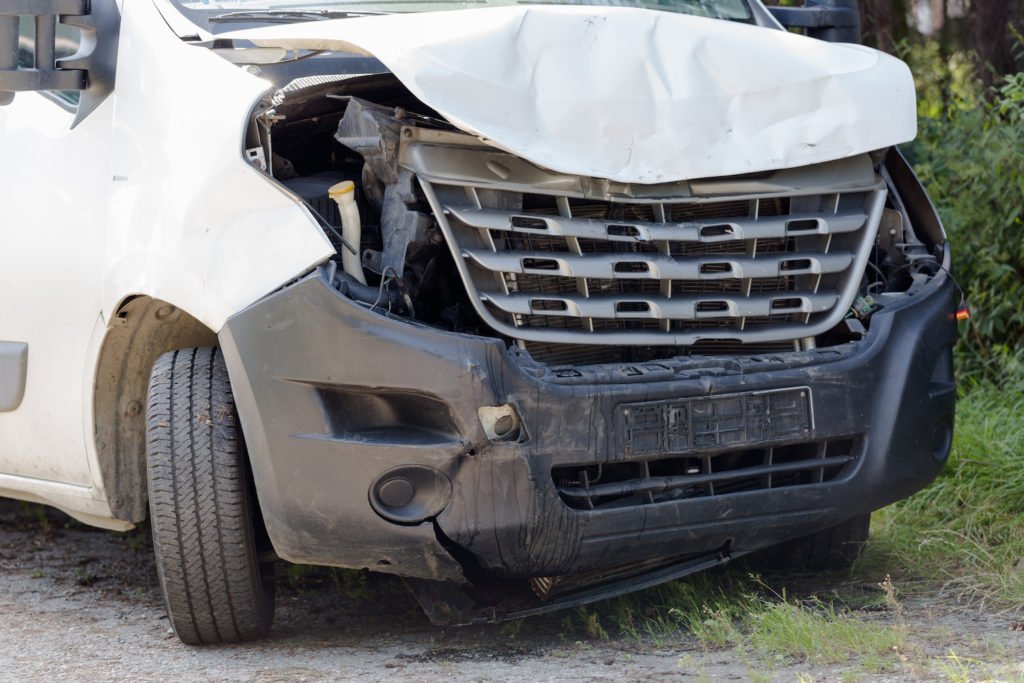 Commercial van with buckled hood from accident