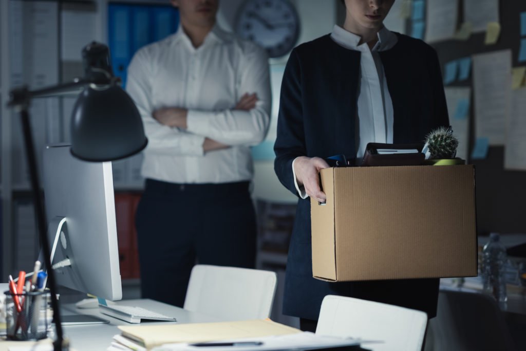 Fired employee with box leaving office