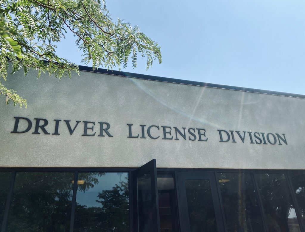 DMV building entrance that says "driver license division"