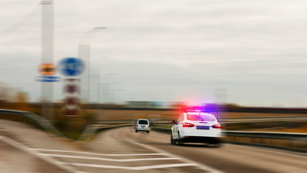 Police car chasing a driver on the highway