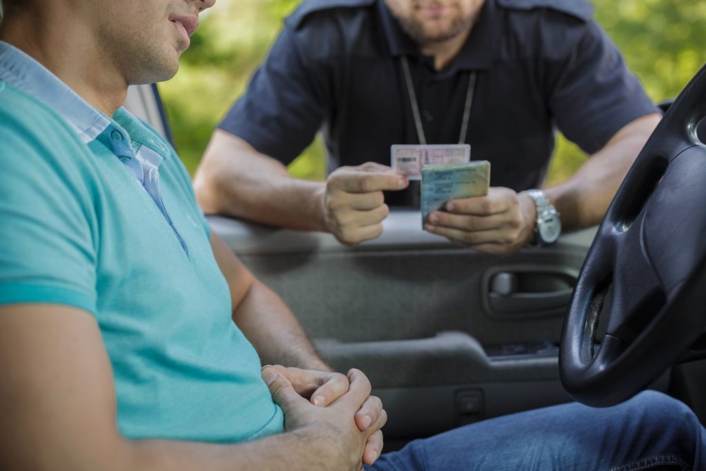 Police checking license of DUI driver