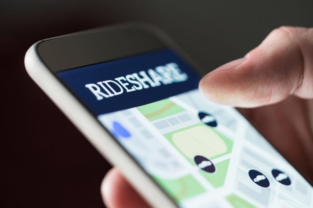 Closeup of DUI defendant holding iPhone with rideshare app